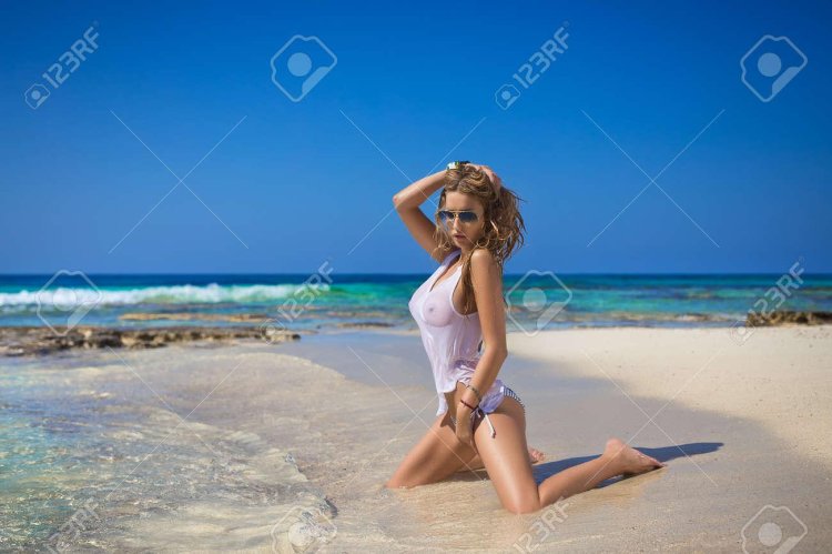 Girls in wet T -shirts on the beach