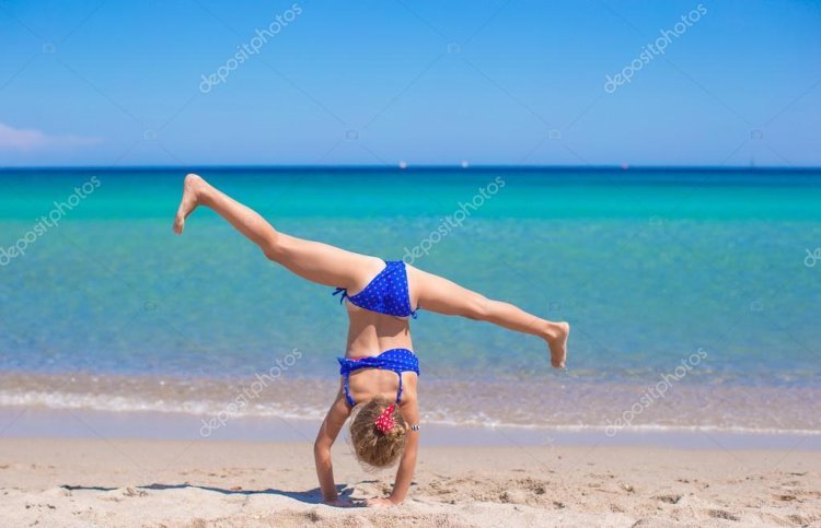 Gymnastics girls are small on the beach