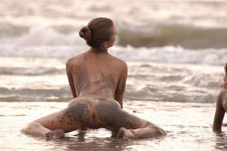 Girl with tattoos on the beach