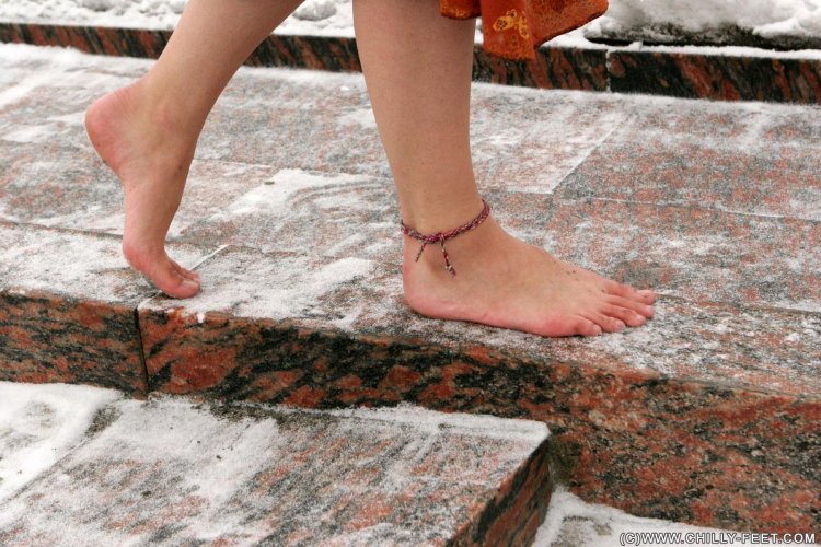 Barefoot in the snow of a girl
