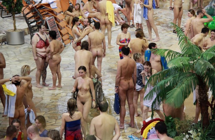 Naked nudist families in the water park