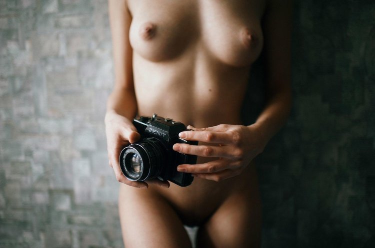 Naked photographer with a camera