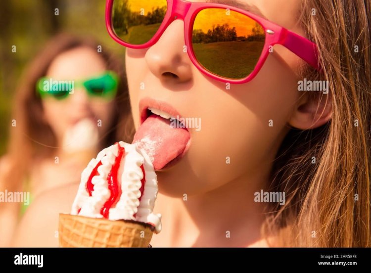The girl licks ice cream