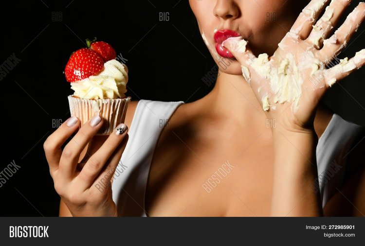 Cream with strawberries on a girl