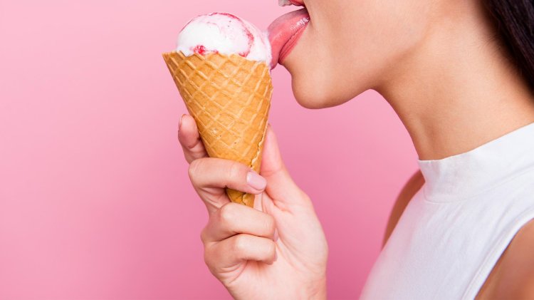 The girl licks ice cream