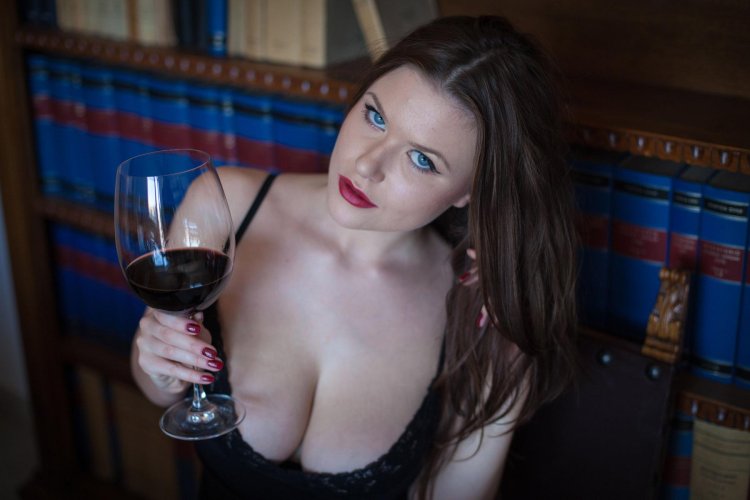 Naked mature with a glass of wine