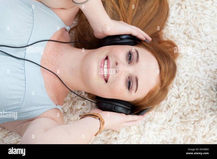 Red girl listens to music