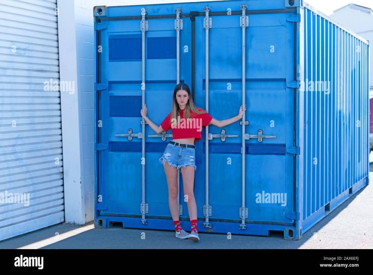Girls against the background of containers