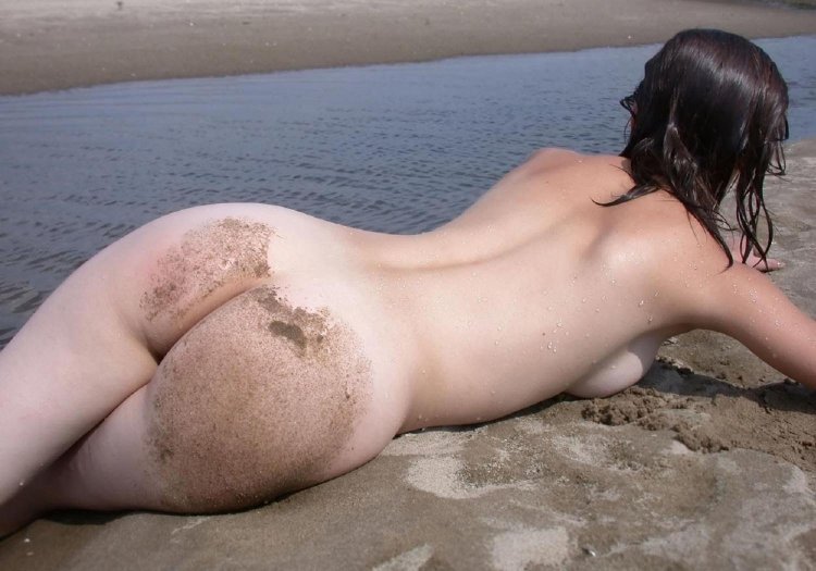 Naked female butt on the beach