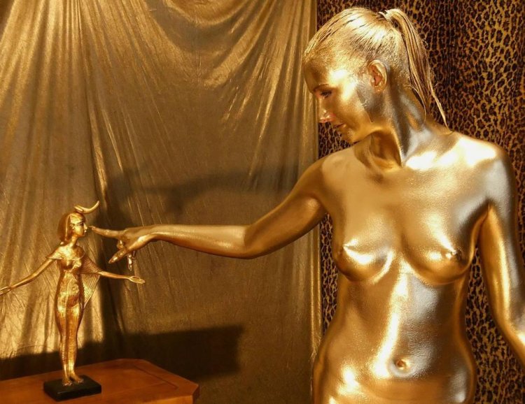 Naked woman in gold paint