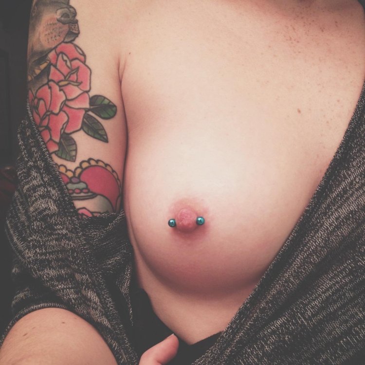 Little female breasts with piercing