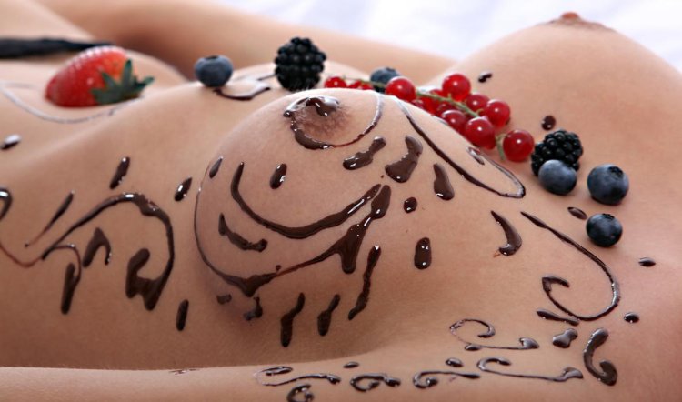 Naked female breasts in chocolate