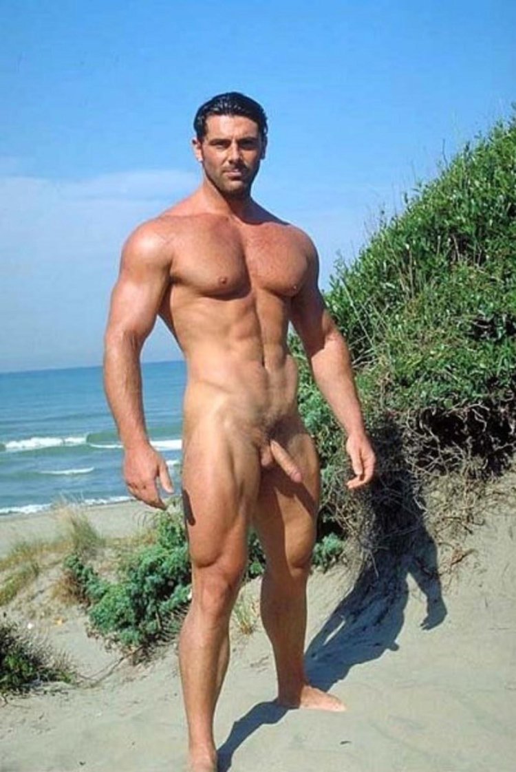 Muscular naked guy on the beach