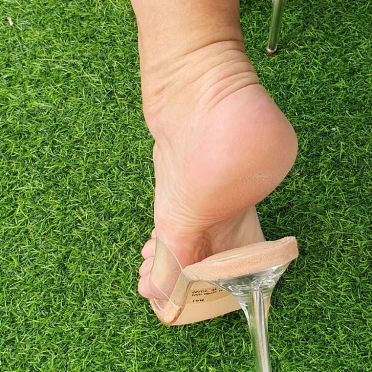 Feet in sabo on stilettos