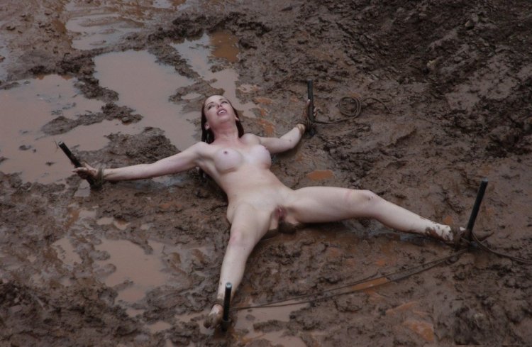 Naked women associated in mud