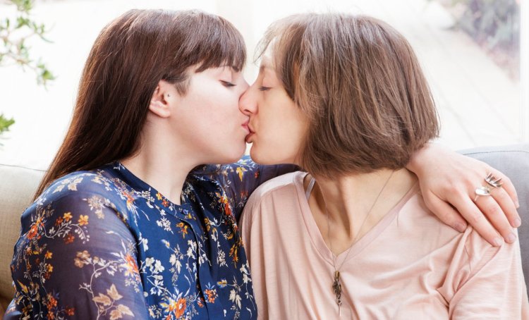 Mom and daughter French kiss