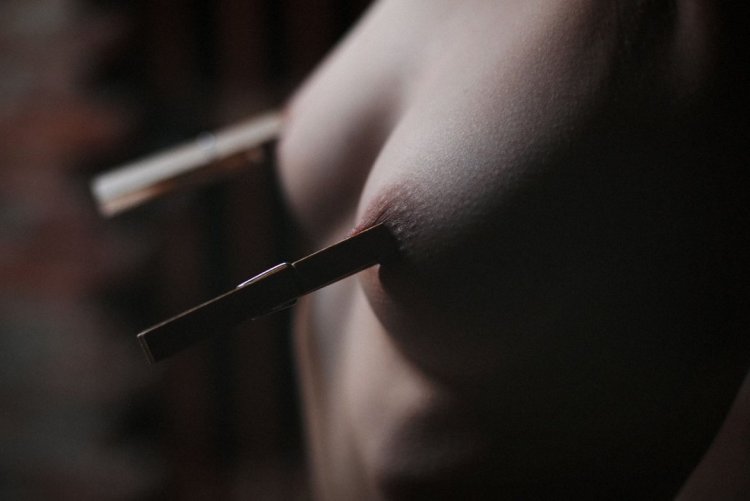 Women's nipples with a clothespin