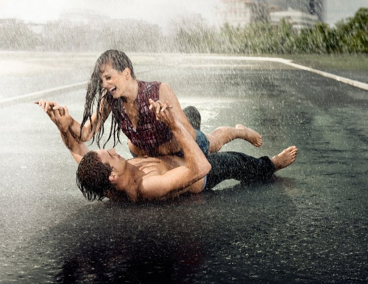 A guy with a girl in the rain