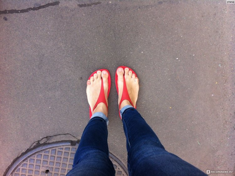 Barefoot girl bites a barefoot guy by the toes