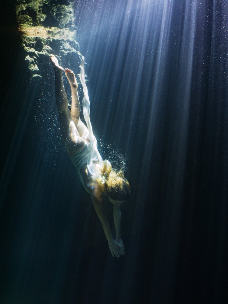 The girl is floating under water