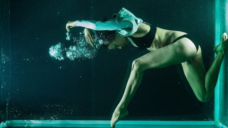 Beautiful girl with booty swims in the ocean