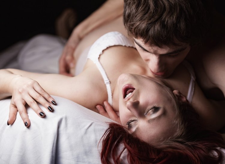 A man and feminine in bed