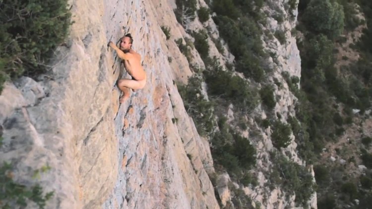 He is engaged in climbing naked