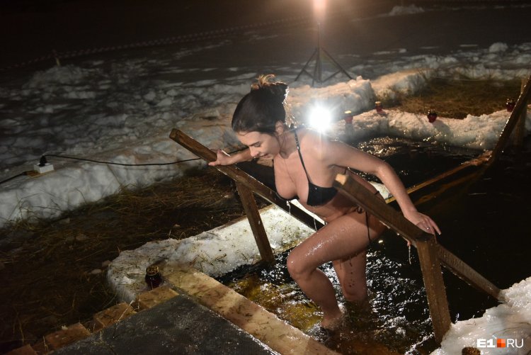 In a swimsuit and boots